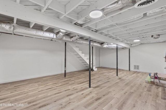 340 Gilbert St, Morristown, TN 37814 - finished below grade area with light wood finished floors, stairs, and baseboards