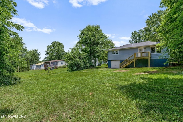 340 Gilbert St, Morristown, TN 37814 - view of grassy yard with stairway, a garage, and a wooden deck