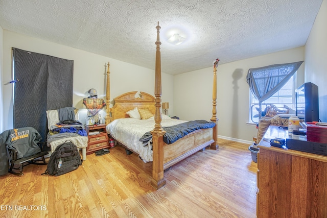 120 Rew St, Oakdale, TN 37829 - bedroom featuring light wood-style flooring, a textured ceiling, and baseboards