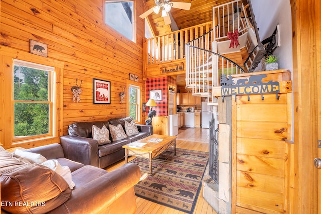 407 Big Bear Way, Pigeon Forge, TN 37863 - living room featuring a ceiling fan, wooden walls, light wood-style floors, and high vaulted ceiling