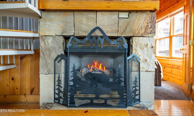 407 Big Bear Way, Pigeon Forge, TN 37863 - detailed view of a warm lit fireplace, wood finished floors, and wooden walls