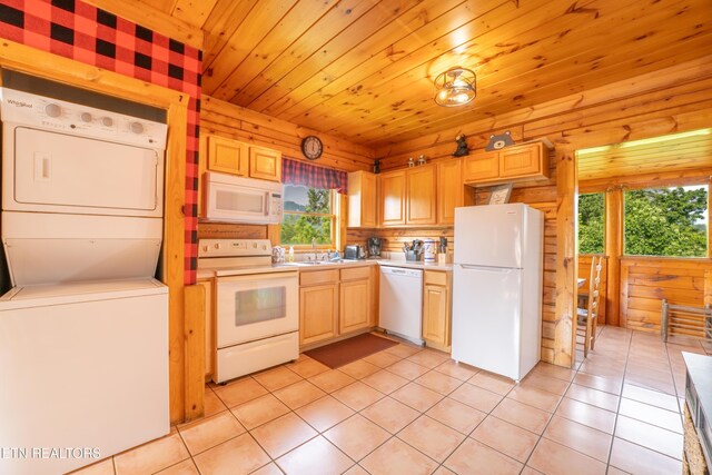 407 Big Bear Way, Pigeon Forge, TN 37863 - kitchen featuring white appliances, stacked washing machine and dryer, light countertops, light tile patterned floors, and light brown cabinetry