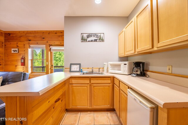 407 Big Bear Way, Pigeon Forge, TN 37863 - kitchen with white appliances, a peninsula, a sink, light countertops, and light tile patterned floors