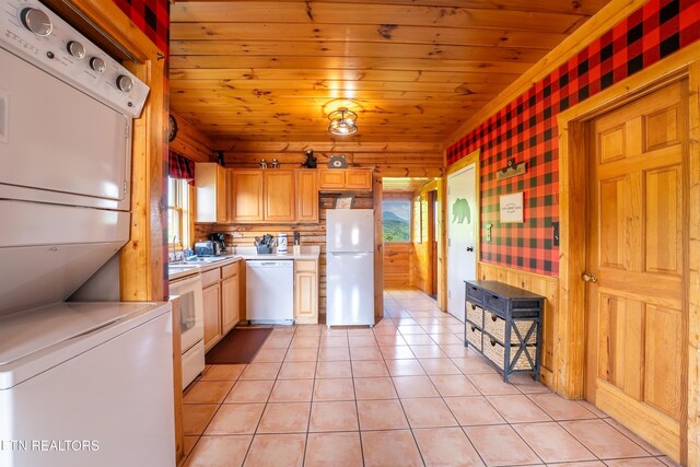 407 Big Bear Way, Pigeon Forge, TN 37863 - kitchen featuring white appliances, light countertops, plenty of natural light, stacked washer / dryer, and wood ceiling