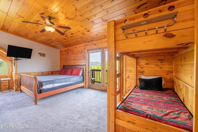 407 Big Bear Way, Pigeon Forge, TN 37863 - carpeted bedroom featuring wood walls, access to exterior, wood ceiling, and a ceiling fan