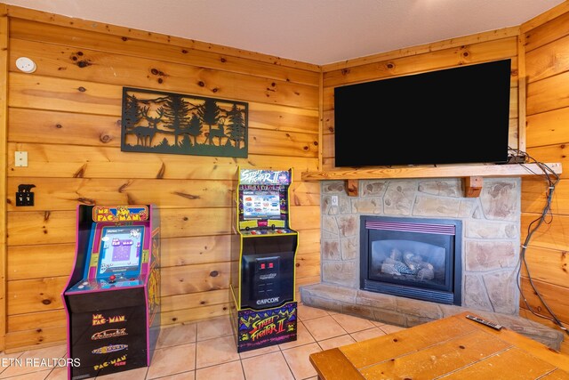 407 Big Bear Way, Pigeon Forge, TN 37863 - living area featuring tile patterned floors, a stone fireplace, and wood walls