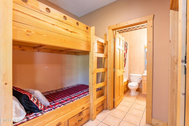 407 Big Bear Way, Pigeon Forge, TN 37863 - bedroom with light tile patterned floors and connected bathroom