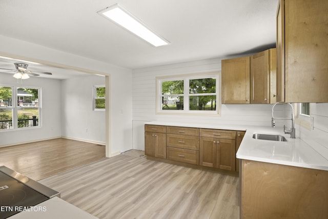 508 E Oldham Ave, Knoxville, TN 37917 - kitchen featuring a sink, brown cabinets, light wood finished floors, light countertops, and ceiling fan