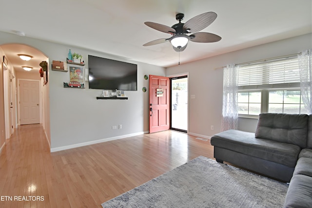 615 Mary St, Russellville, TN 37860 - living room with light wood-style flooring, arched walkways, ceiling fan, and baseboards