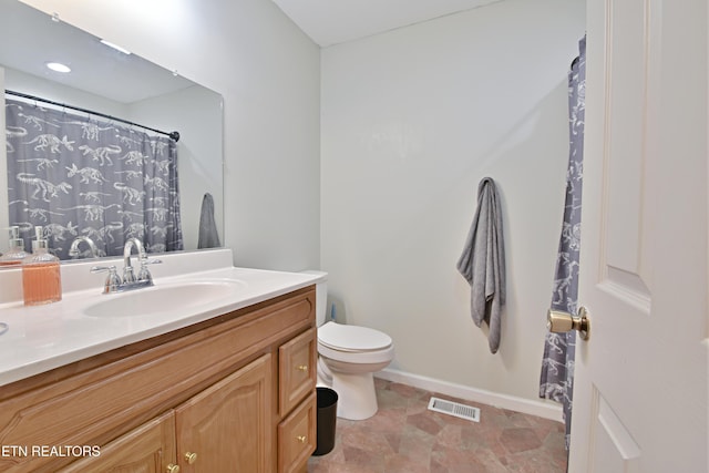 615 Mary St, Russellville, TN 37860 - bathroom featuring vanity, toilet, baseboards, and stone finish floors
