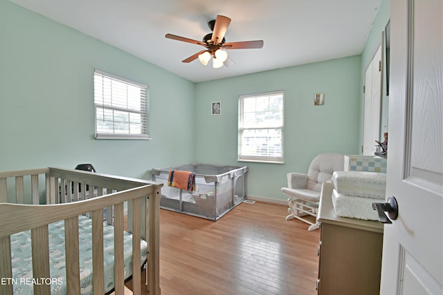 615 Mary St, Russellville, TN 37860 - bedroom featuring multiple windows, light wood-style flooring, a crib, and baseboards