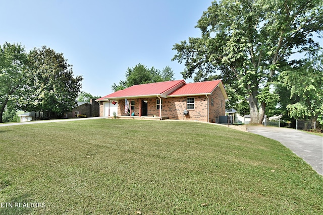 615 Mary St, Russellville, TN 37860 - ranch-style home with concrete driveway, a garage, metal roof, and a front yard