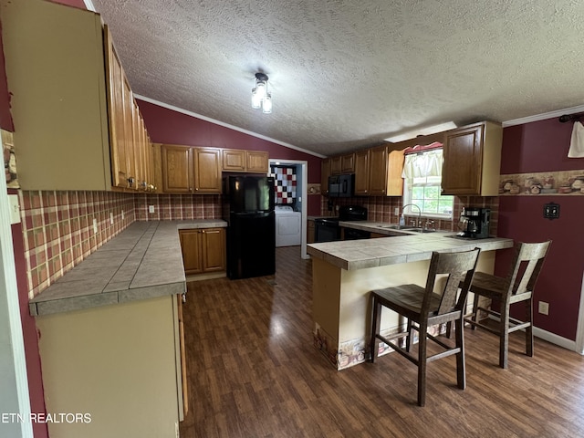 108 Hawn Dr, Crab Orchard, TN 37723 - kitchen with black appliances, a peninsula, a sink, dark wood-type flooring, and crown molding