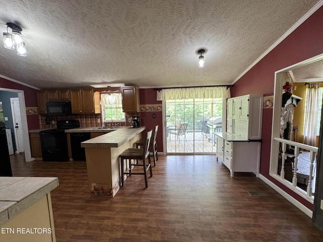 108 Hawn Dr, Crab Orchard, TN 37723 - kitchen with black appliances, tile countertops, a sink, ornamental molding, and dark wood-style floors