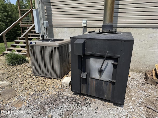 108 Hawn Dr, Crab Orchard, TN 37723 - exterior view of cooling unit and a wood stove