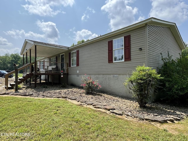 108 Hawn Dr, Crab Orchard, TN 37723 - view of home's exterior featuring crawl space, a yard, and stairway