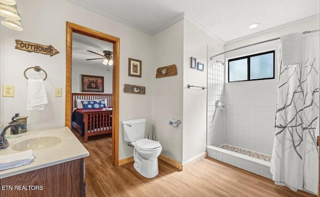 725 Sunshine Trl, Gatlinburg, TN 37738 - bathroom featuring ornamental molding, toilet, wood finished floors, a tile shower, and vanity