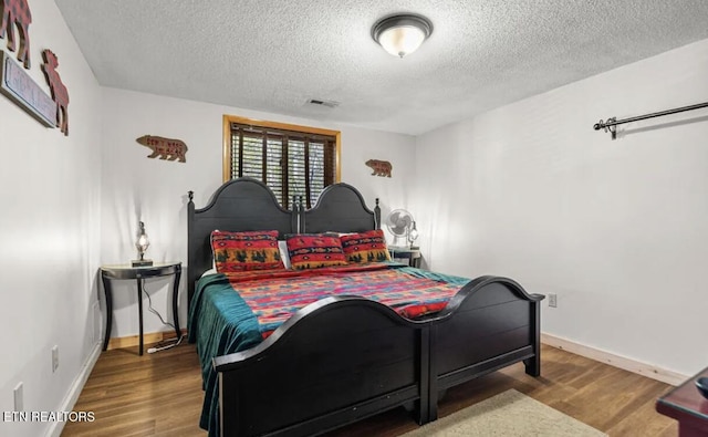 725 Sunshine Trl, Gatlinburg, TN 37738 - bedroom with wood finished floors, a textured ceiling, and baseboards