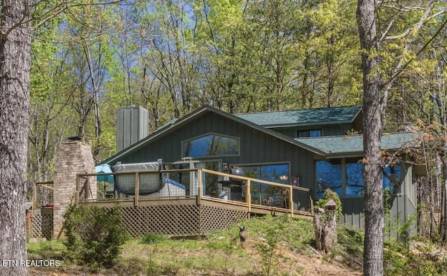 725 Sunshine Trl, Gatlinburg, TN 37738 - rear view of property featuring roof with shingles, a deck, and a chimney