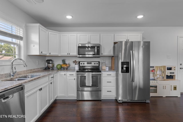 137 Storm Ln, Jacksboro, TN 37757 - kitchen with appliances with stainless steel finishes, a sink, light stone countertops, recessed lighting, and white cabinets
