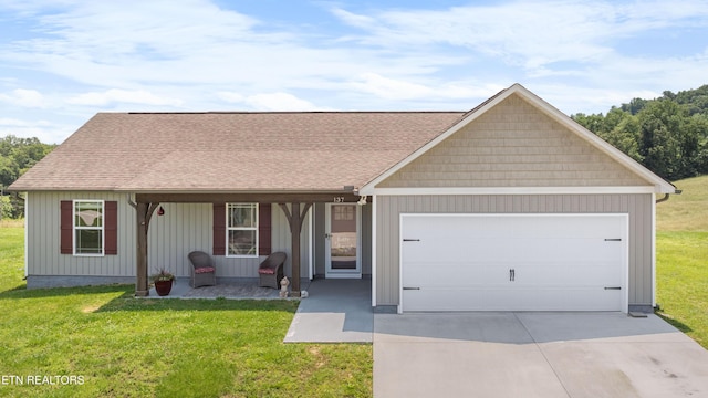 137 Storm Ln, Jacksboro, TN 37757 - view of front facade with an attached garage, concrete driveway, a front yard, and covered porch