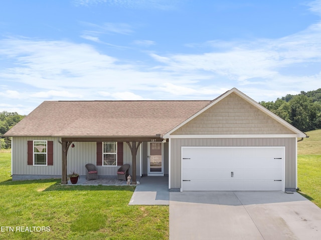 137 Storm Ln, Jacksboro, TN 37757 - view of front of property featuring a garage, driveway, a front yard, and a porch