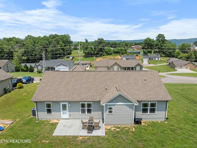 137 Storm Ln, Jacksboro, TN 37757 - back of house with a shingled roof, a patio, cooling unit, and a lawn