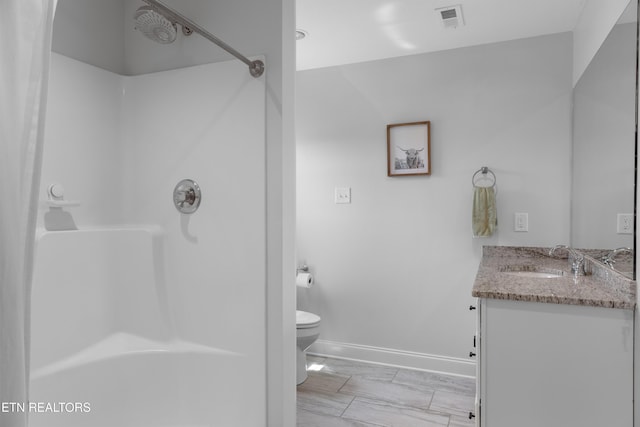 137 Storm Ln, Jacksboro, TN 37757 - full bathroom with toilet, vanity, a shower, and baseboards