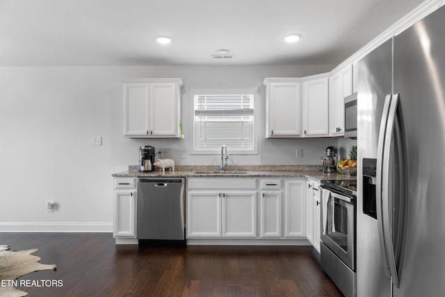 137 Storm Ln, Jacksboro, TN 37757 - kitchen featuring stainless steel appliances, a sink, white cabinetry, light stone counters, and recessed lighting