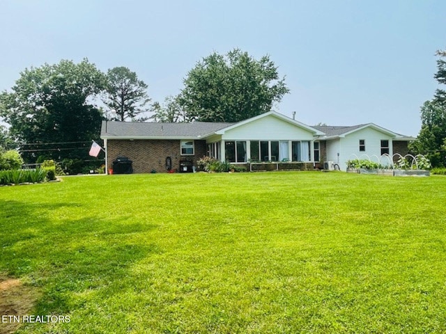 834 Hinkle Estates Dr, Seymour, TN 37865 - rear view of house with a lawn and a sunroom