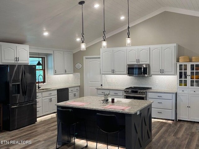 834 Hinkle Estates Dr, Seymour, TN 37865 - kitchen with black appliances, crown molding, vaulted ceiling, a sink, and white cabinets