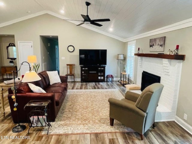834 Hinkle Estates Dr, Seymour, TN 37865 - living room with wood finished floors, a ceiling fan, baseboards, vaulted ceiling, and a brick fireplace
