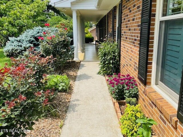 834 Hinkle Estates Dr, Seymour, TN 37865 - view of home's exterior featuring brick siding and covered porch