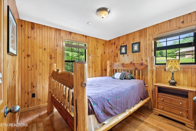 2295 Bluff Mountain Rd, Sevierville, TN 37876 - bedroom featuring wood finished floors and wood walls