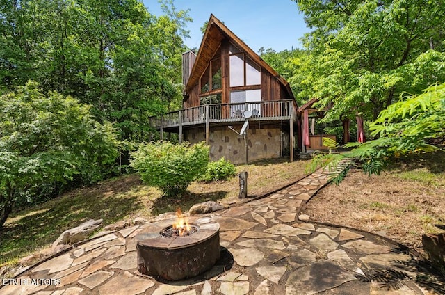2295 Bluff Mountain Rd, Sevierville, TN 37876 - back of house with a fire pit, a patio, a chimney, and a wooden deck