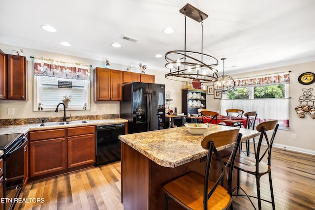 151 Utsesti Way, Loudon, TN 37774 - kitchen with a sink, black appliances, ornamental molding, a chandelier, and a breakfast bar area