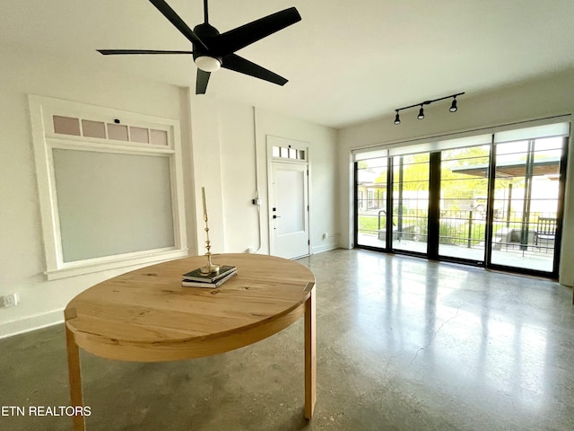 3415 N Broadway St Unit 105, Knoxville, TN 37917 - dining room with baseboards, a ceiling fan, finished concrete floors, and rail lighting