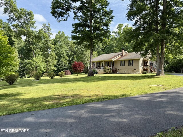 406 Asheville Hwy, Strawberry Plains, TN 37871 - view of front facade with crawl space, a front lawn, and a chimney
