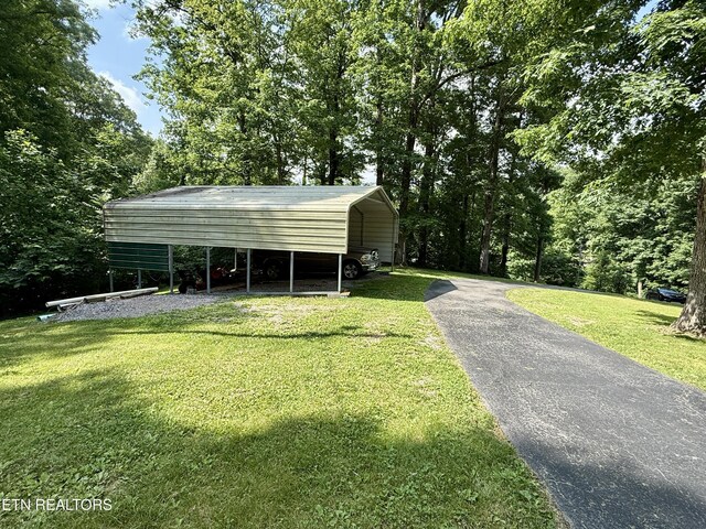 406 Asheville Hwy, Strawberry Plains, TN 37871 - view of side of property featuring driveway, a yard, and a carport