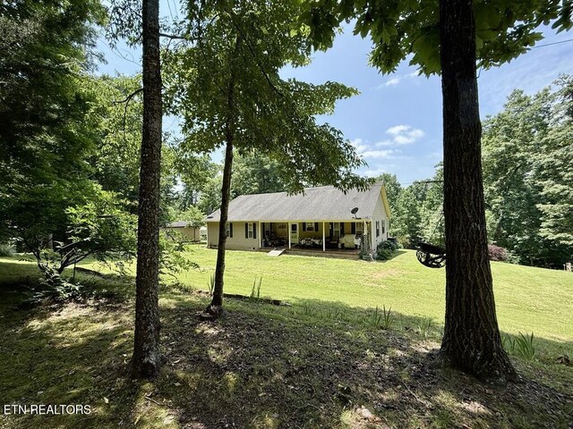 406 Asheville Hwy, Strawberry Plains, TN 37871 - view of front of home featuring covered porch and a front lawn