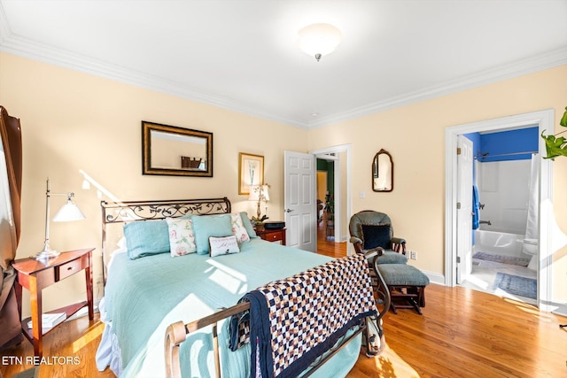 300 County Road 876, Englewood, TN 37329 - bedroom featuring crown molding, wood finished floors, baseboards, and connected bathroom