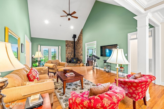 300 County Road 876, Englewood, TN 37329 - living room with high vaulted ceiling, a wood stove, ceiling fan, wood finished floors, and ornate columns