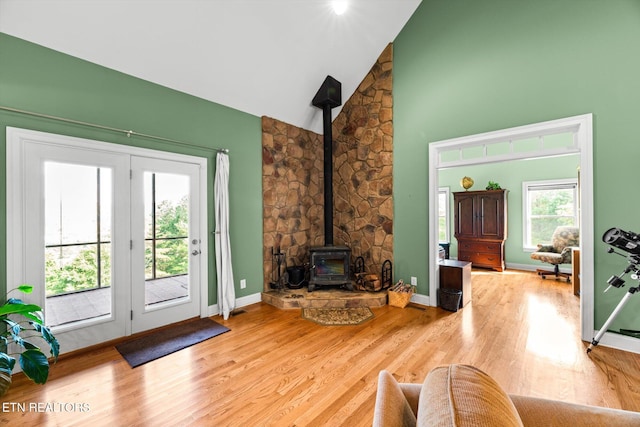 300 County Road 876, Englewood, TN 37329 - living room with a wood stove, wood finished floors, high vaulted ceiling, and baseboards
