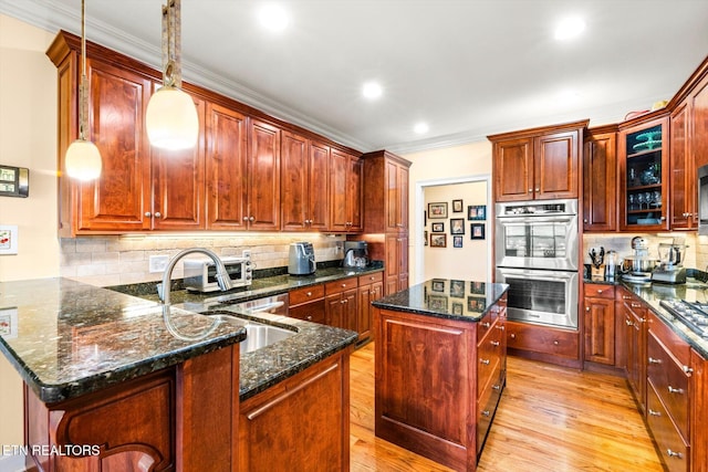 300 County Road 876, Englewood, TN 37329 - kitchen with double oven, ornamental molding, a sink, backsplash, and light wood-style flooring