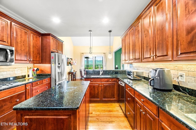 300 County Road 876, Englewood, TN 37329 - kitchen featuring stainless steel appliances, a sink, tasteful backsplash, light wood finished floors, and a peninsula