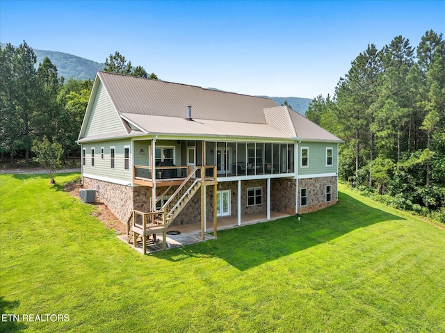 300 County Road 876, Englewood, TN 37329 - back of property with stone siding, a patio, central AC unit, and a sunroom