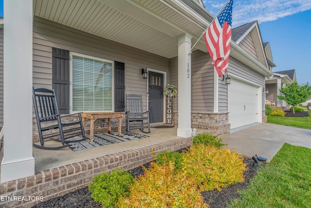 102 Deerberry Ln, Oak Ridge, TN 37830 - covered porch featuring driveway and an attached garage