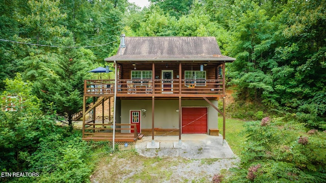 1121 Turkey Ridge Way, Seymour, TN 37865 - rear view of house featuring a deck, a garage, a forest view, and log exterior