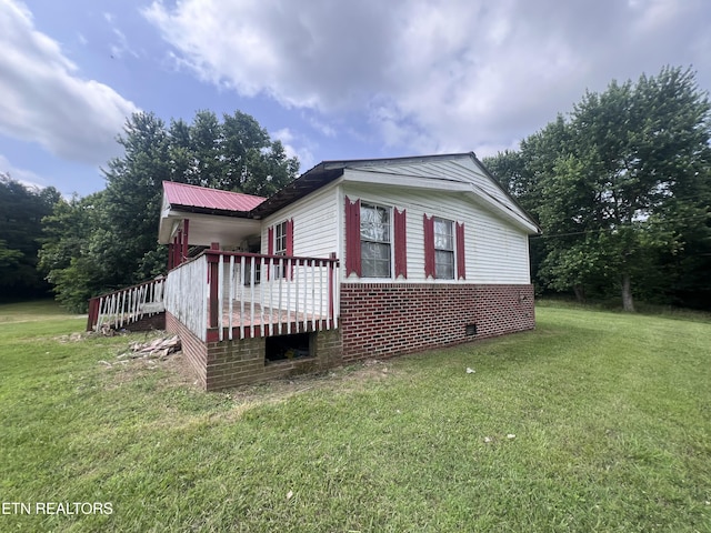 1311 Old Union Rd, Hilham, TN 38568 - view of property exterior with a lawn, brick siding, and crawl space