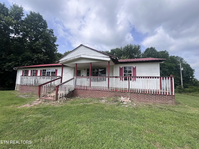 1311 Old Union Rd, Hilham, TN 38568 - single story home featuring covered porch, a front lawn, and metal roof